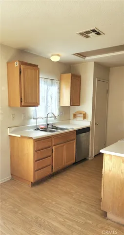a kitchen with granite countertop a sink cabinets and window