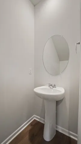 a bathroom with a sink toilet and mirror
