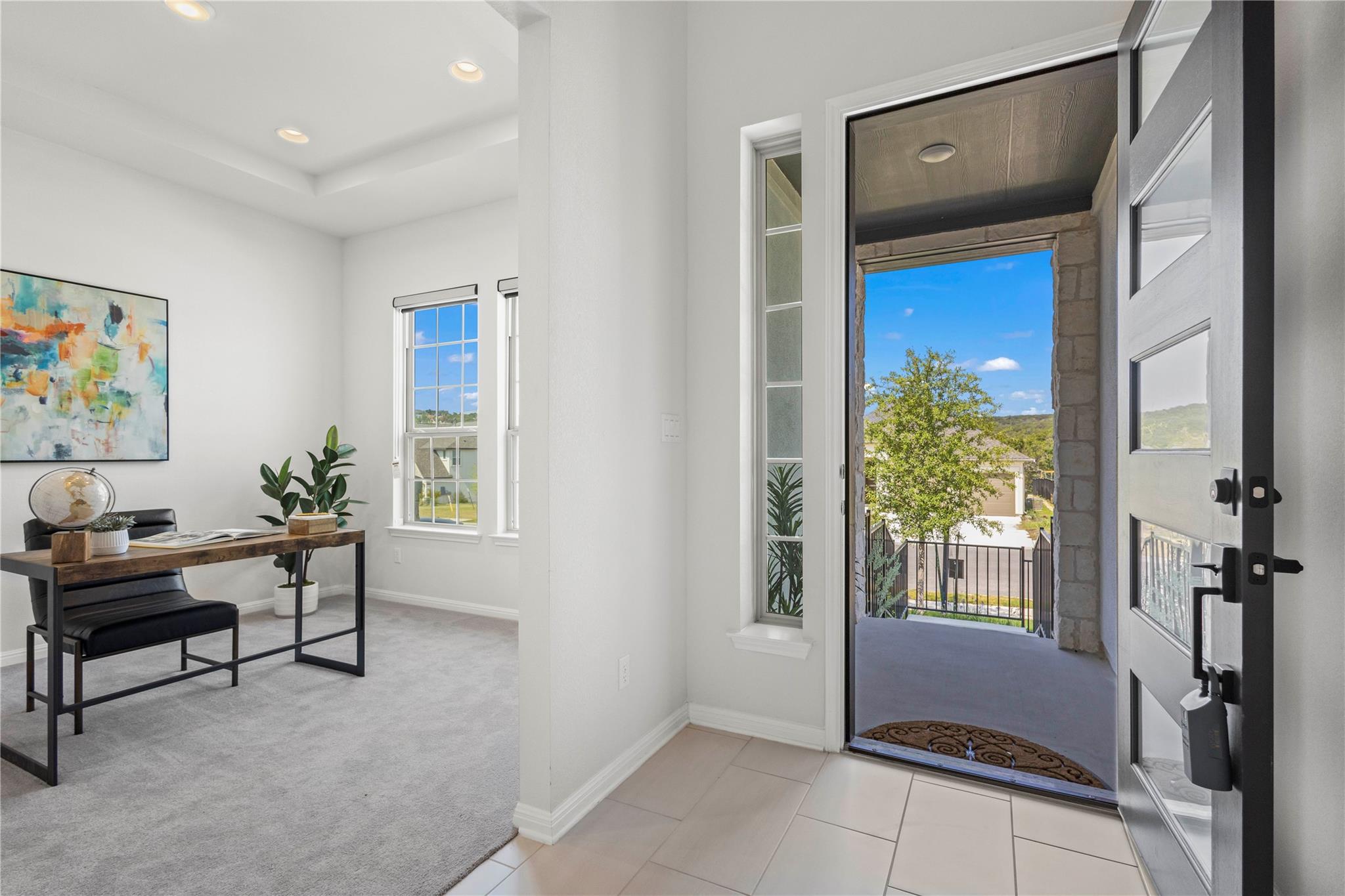 1128 Villa Rialto View Leander, TX 78641 - Photo 7 of 40 A welcoming entry features a paneled door with glass inserts and opens to a well-lit study.