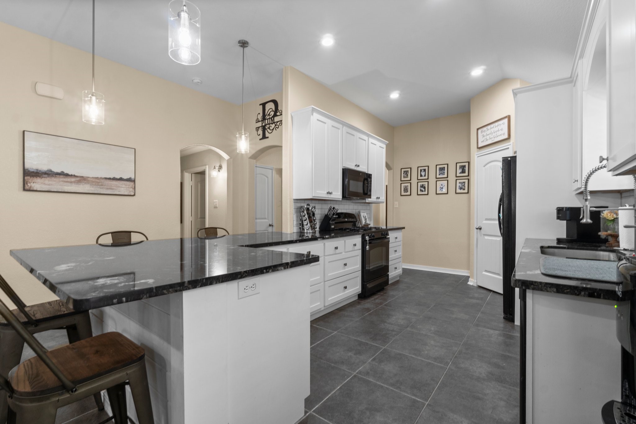 28987 Birch Green Way Spring, TX 77386 - Photo 2 of 32 a kitchen with counter top space cabinets and stainless steel appliances