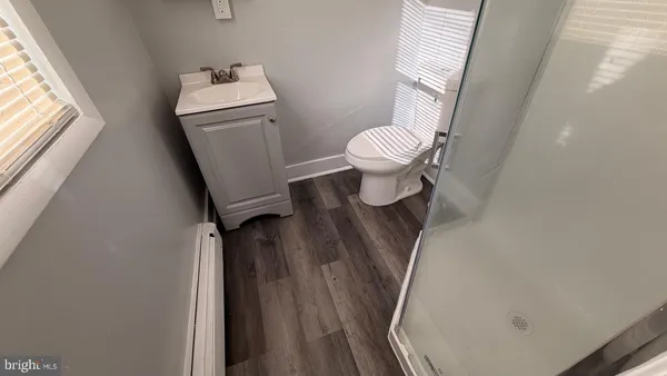 a bathroom with a toilet and a mirror