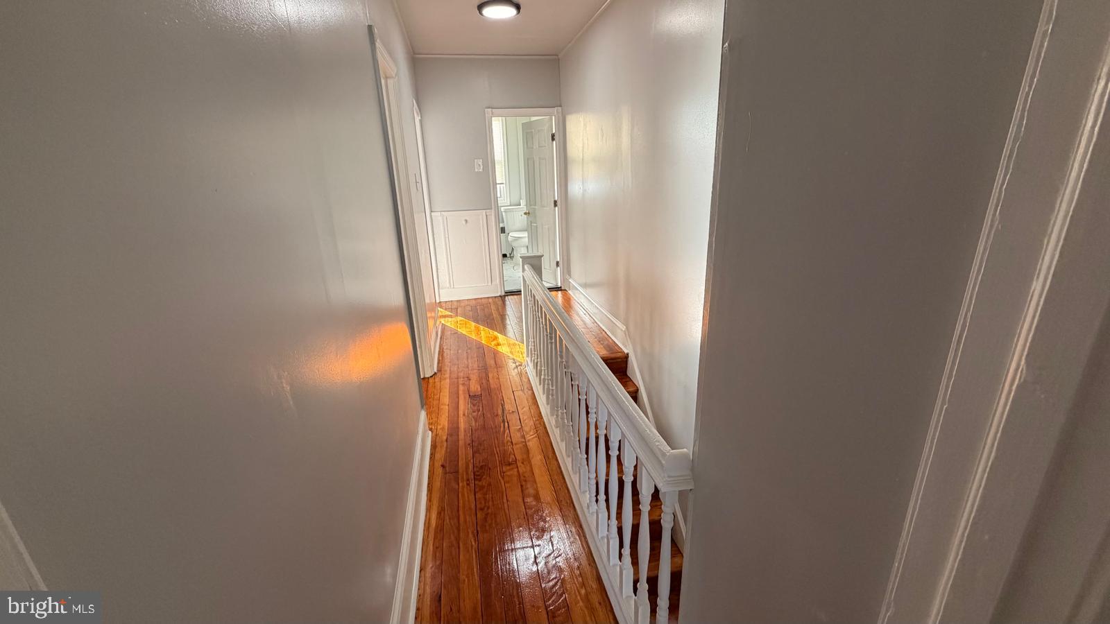 4406 Higbee Street Philadelphia, PA 19135 - Photo 18 of 36 a view of a hallway with wooden floor and stairs