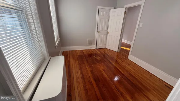 a view of a room with wooden floor and staircase