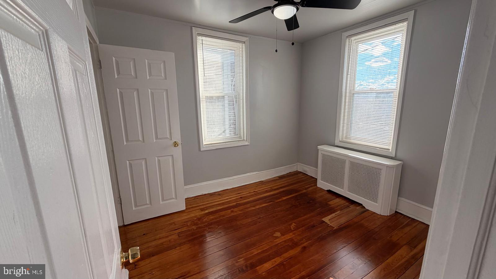 4406 Higbee Street Philadelphia, PA 19135 - Photo 23 of 36 a view of an empty room with wooden floor and a window