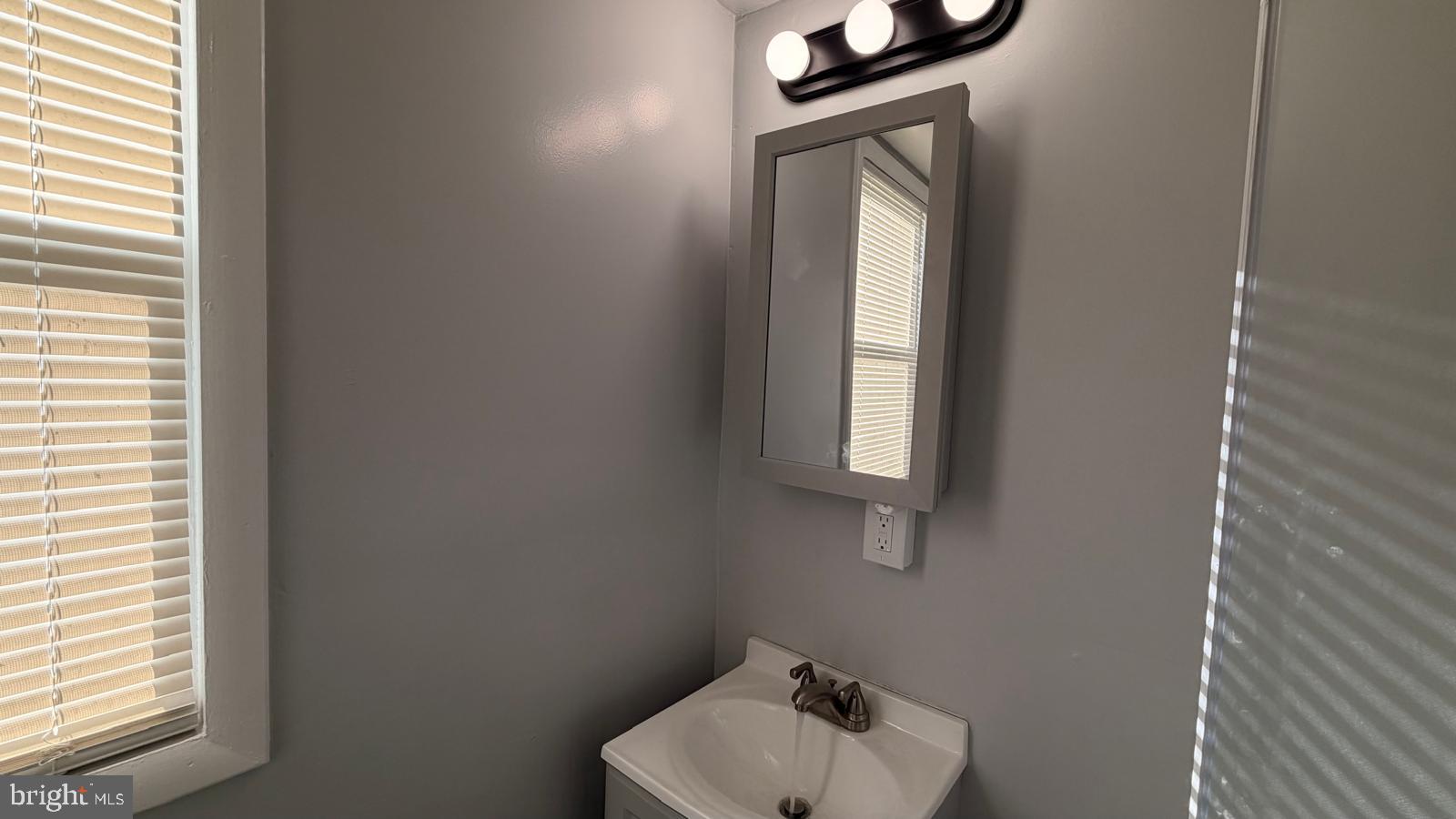 4406 Higbee Street Philadelphia, PA 19135 - Photo 26 of 36 a bathroom with a toilet sink and mirror