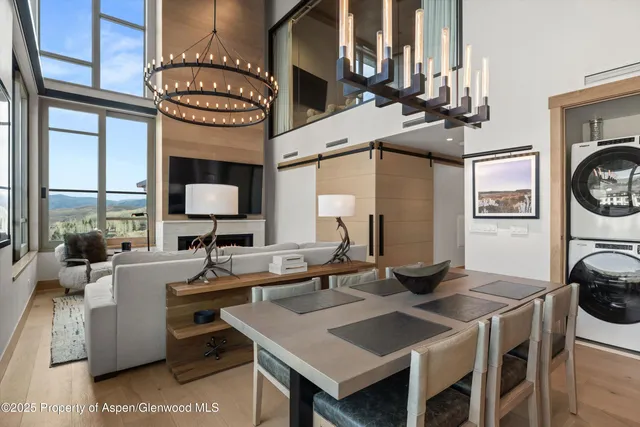 a view of a dining area with furniture and a chandelier