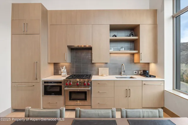 a kitchen with stainless steel appliances a stove and a refrigerator