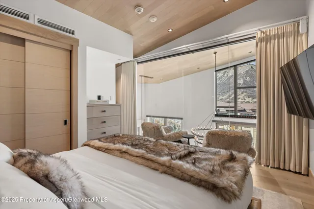 a bedroom with a large bed and a window