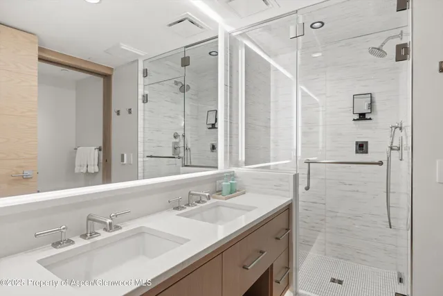 a bathroom with a sink double vanity and shower