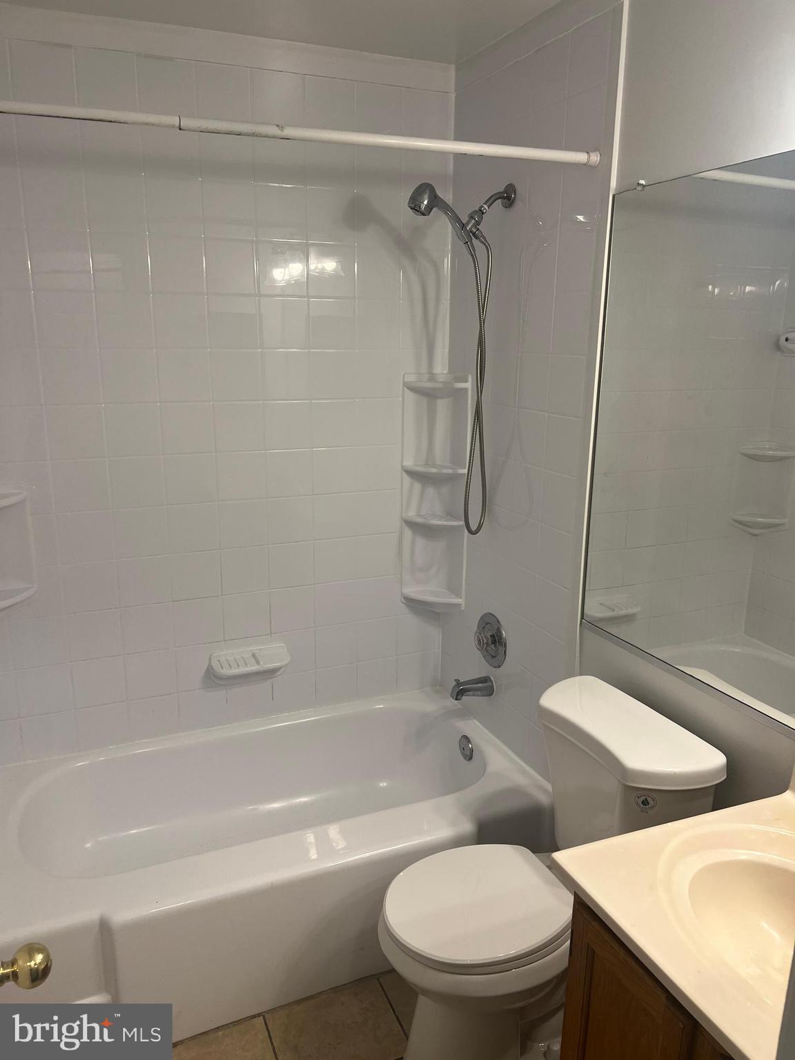 19086 Highstream Drive, Unit 766 Germantown, MD 20874 - Photo 11 of 21 a white toilet and tub sitting next to a bathroom sink