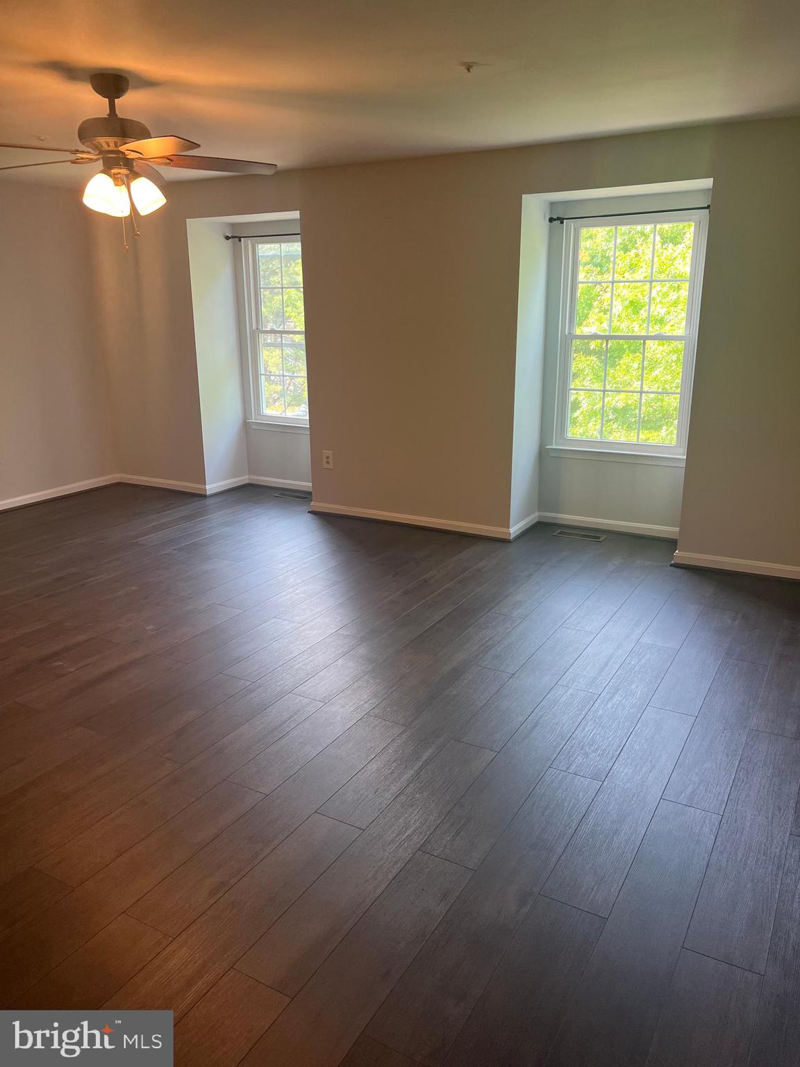 19086 Highstream Drive, Unit 766 Germantown, MD 20874 - Photo 15 of 21 an empty room with wooden floor and windows