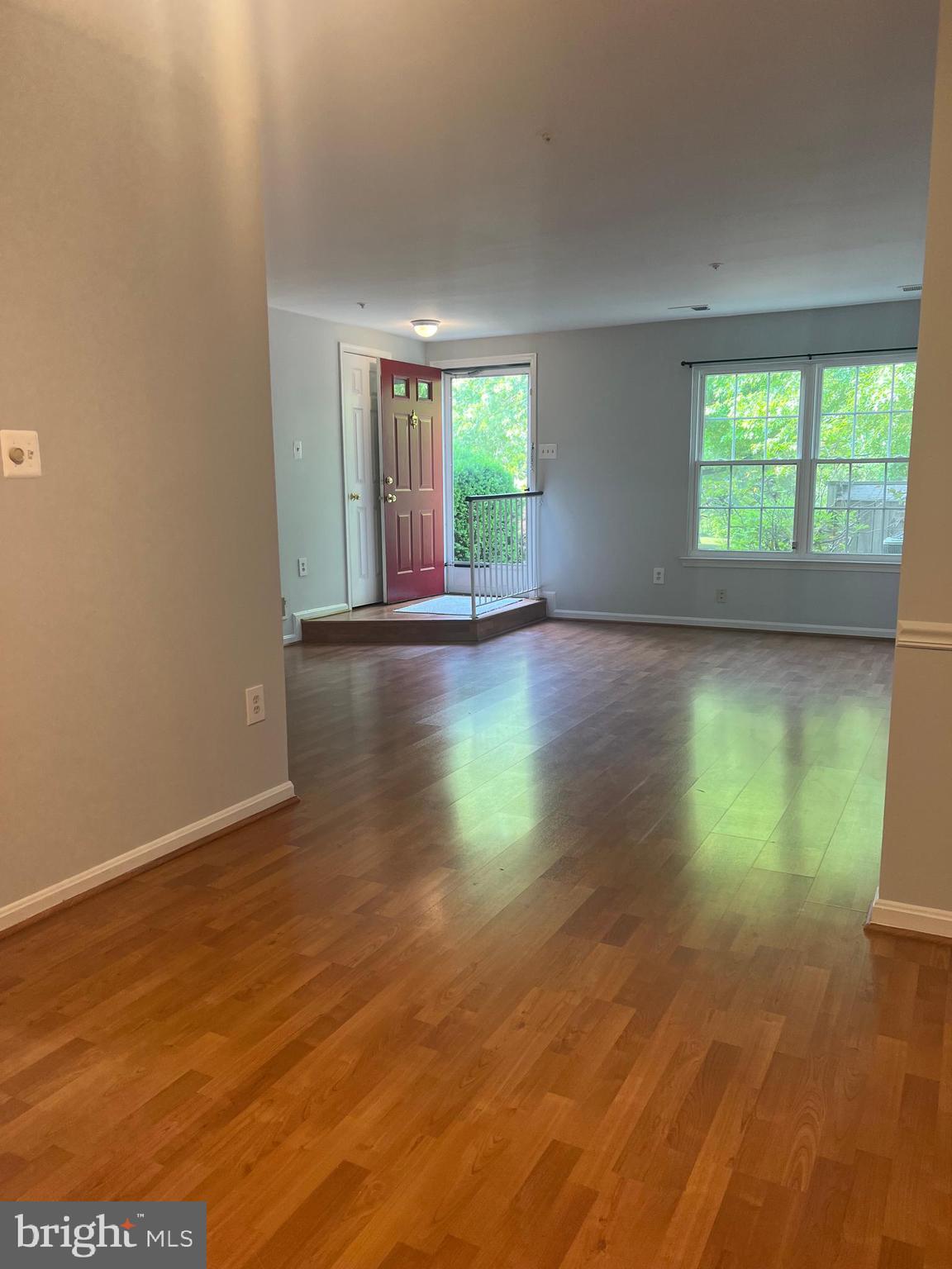 19086 Highstream Drive, Unit 766 Germantown, MD 20874 - Photo 2 of 21 an empty room with wooden floor and windows