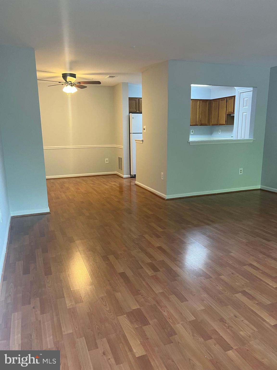 19086 Highstream Drive, Unit 766 Germantown, MD 20874 - Photo 3 of 21 an empty room with wooden floor and windows
