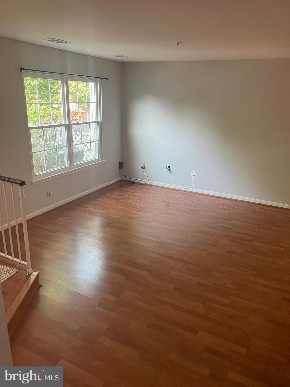 19086 Highstream Drive, Unit 766 Germantown, MD 20874 - Photo 4 of 21 an empty room with wooden floor and windows