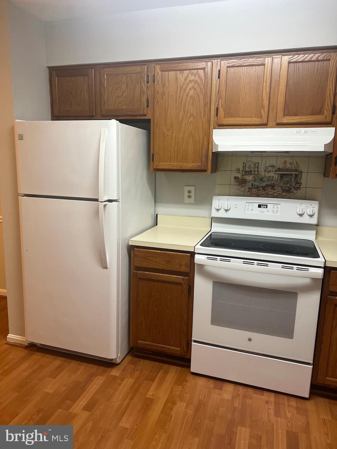 19086 Highstream Drive, Unit 766 Germantown, MD 20874 - Photo 5 of 21 a kitchen with a stove top oven and refrigerator