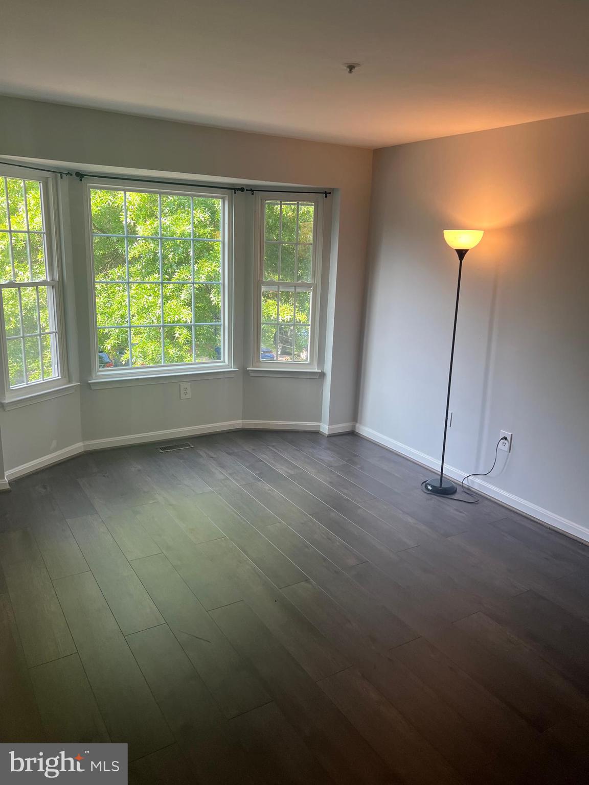 19086 Highstream Drive, Unit 766 Germantown, MD 20874 - Photo 9 of 21 an empty room with wooden floor and windows