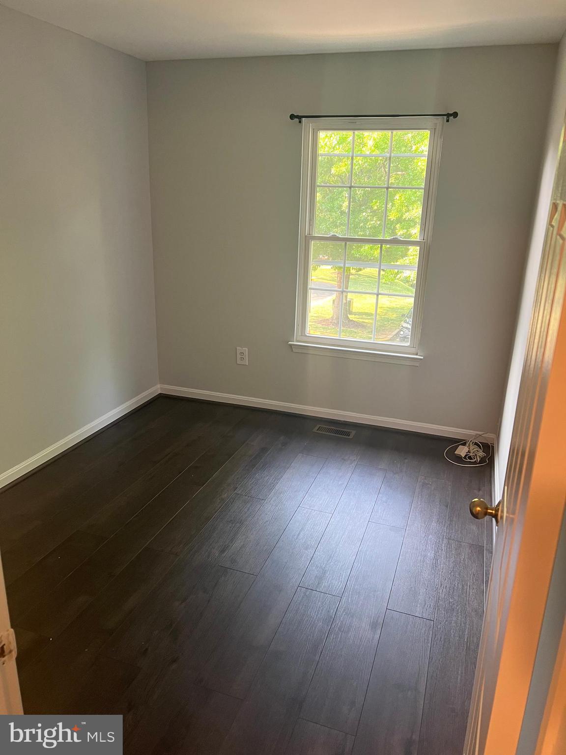 19086 Highstream Drive, Unit 766 Germantown, MD 20874 - Photo 10 of 21 an empty room with wooden floor and windows
