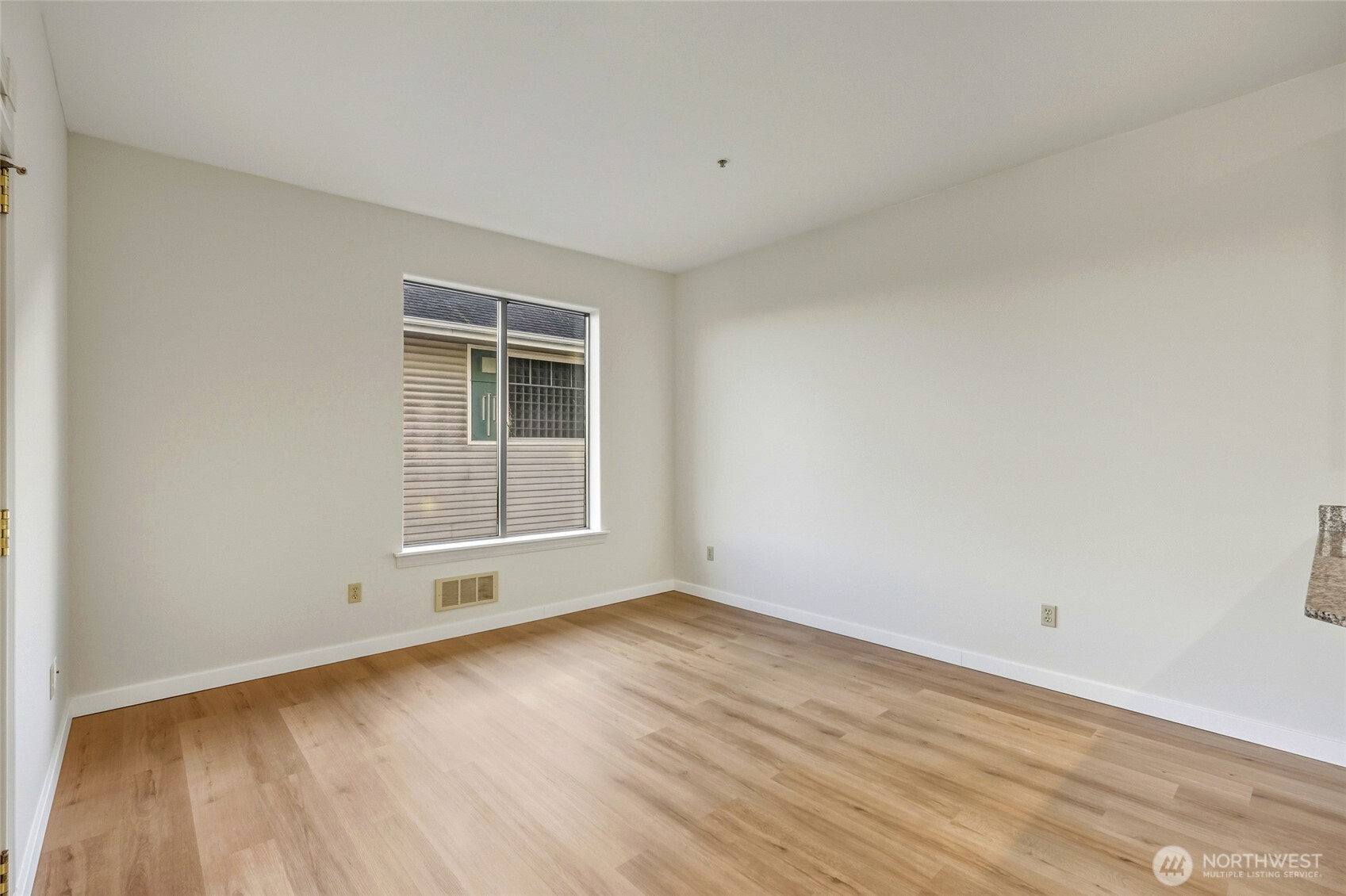 3501 Colby Avenue, Unit 311 Everett, WA 98201 - Photo 10 of 28 an empty room with wooden floor and windows