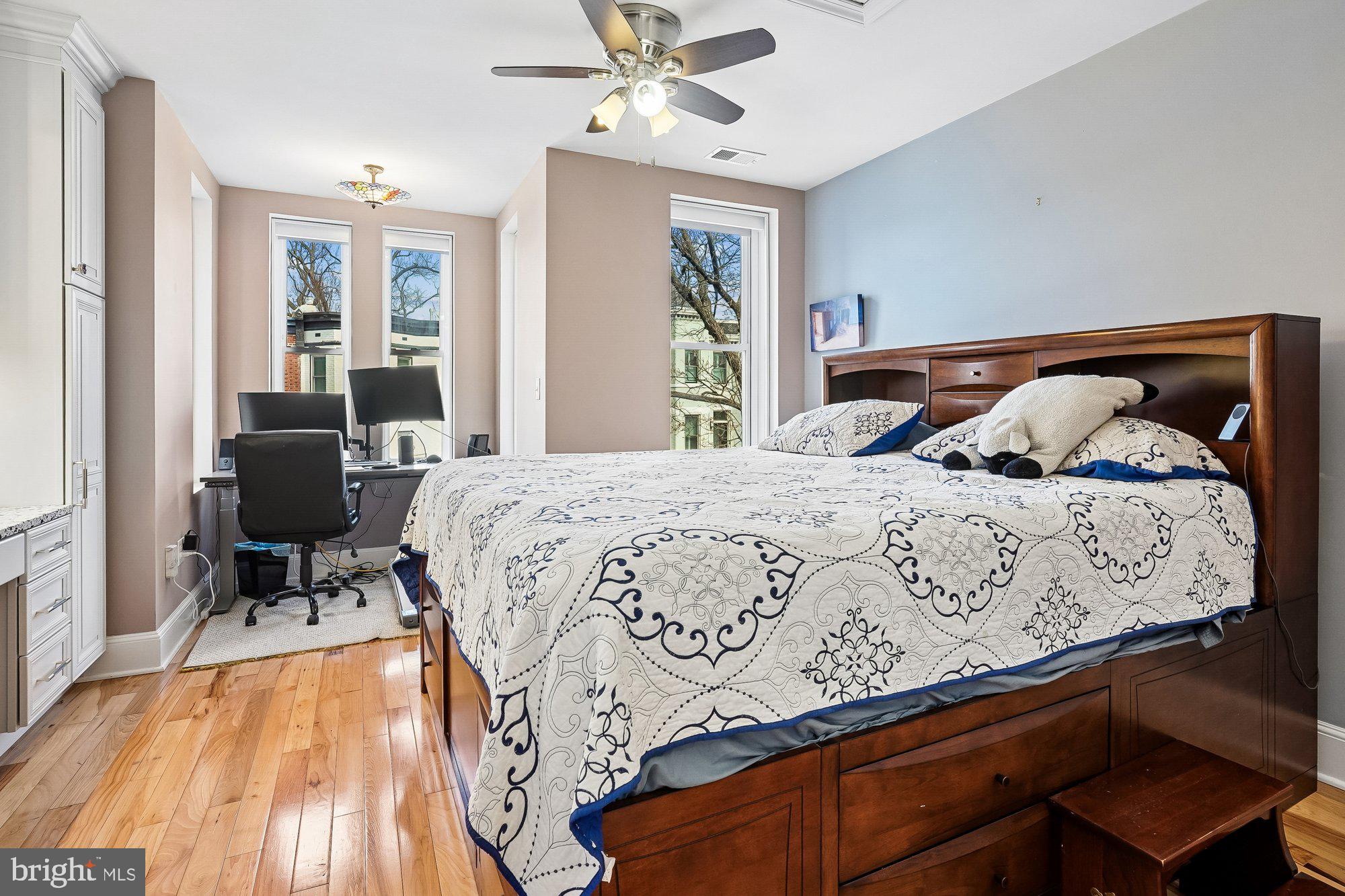909 C Street Northeast Washington, DC 20002 - Photo 20 of 43 a bedroom with a bed and wooden floor