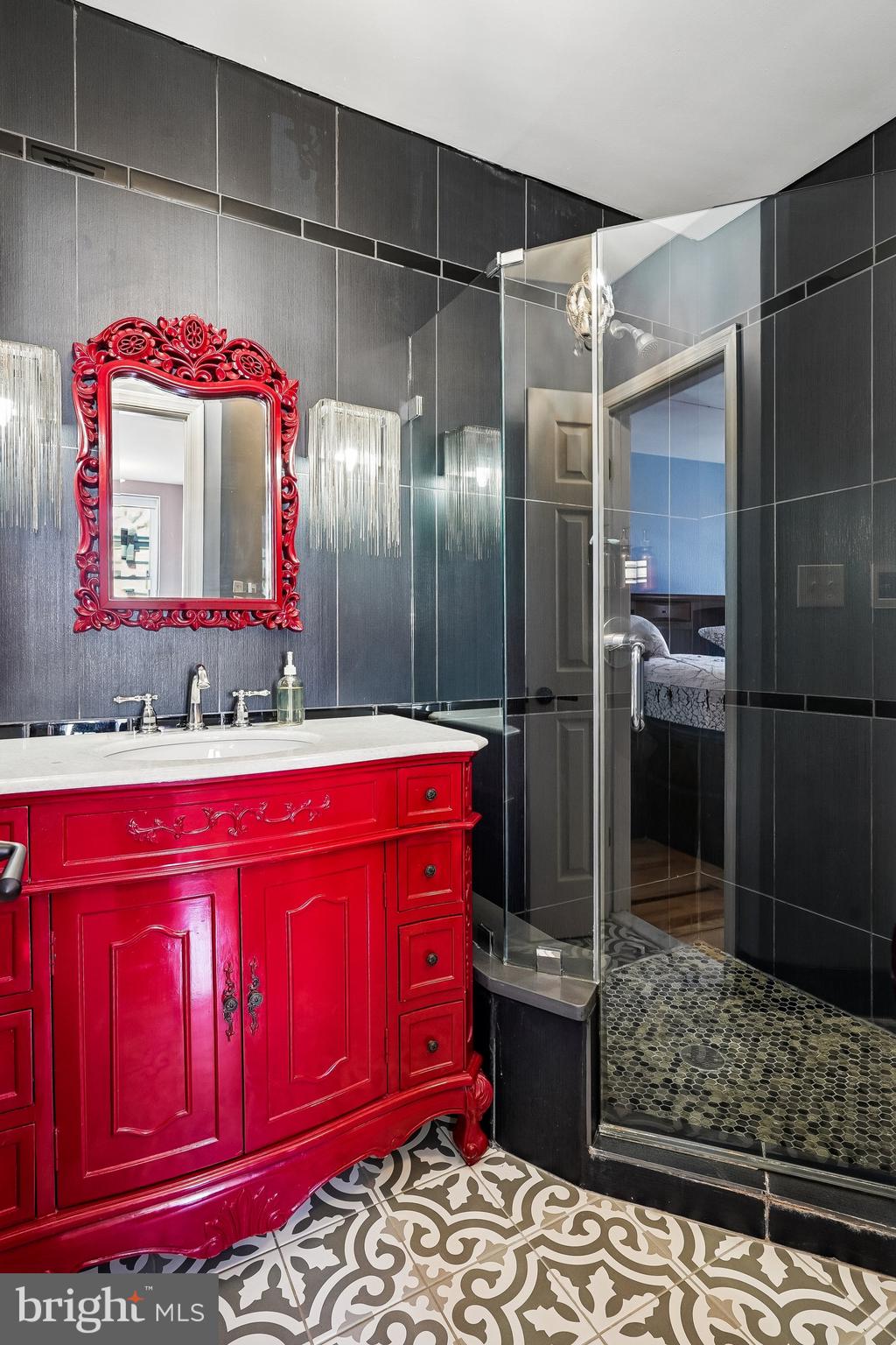 909 C Street Northeast Washington, DC 20002 - Photo 23 of 43 a bathroom with a shower a sink and a mirror