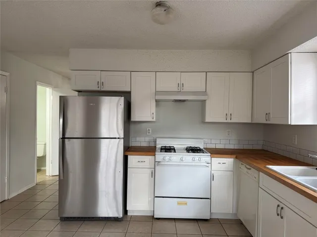 a kitchen with cabinets and white appliances