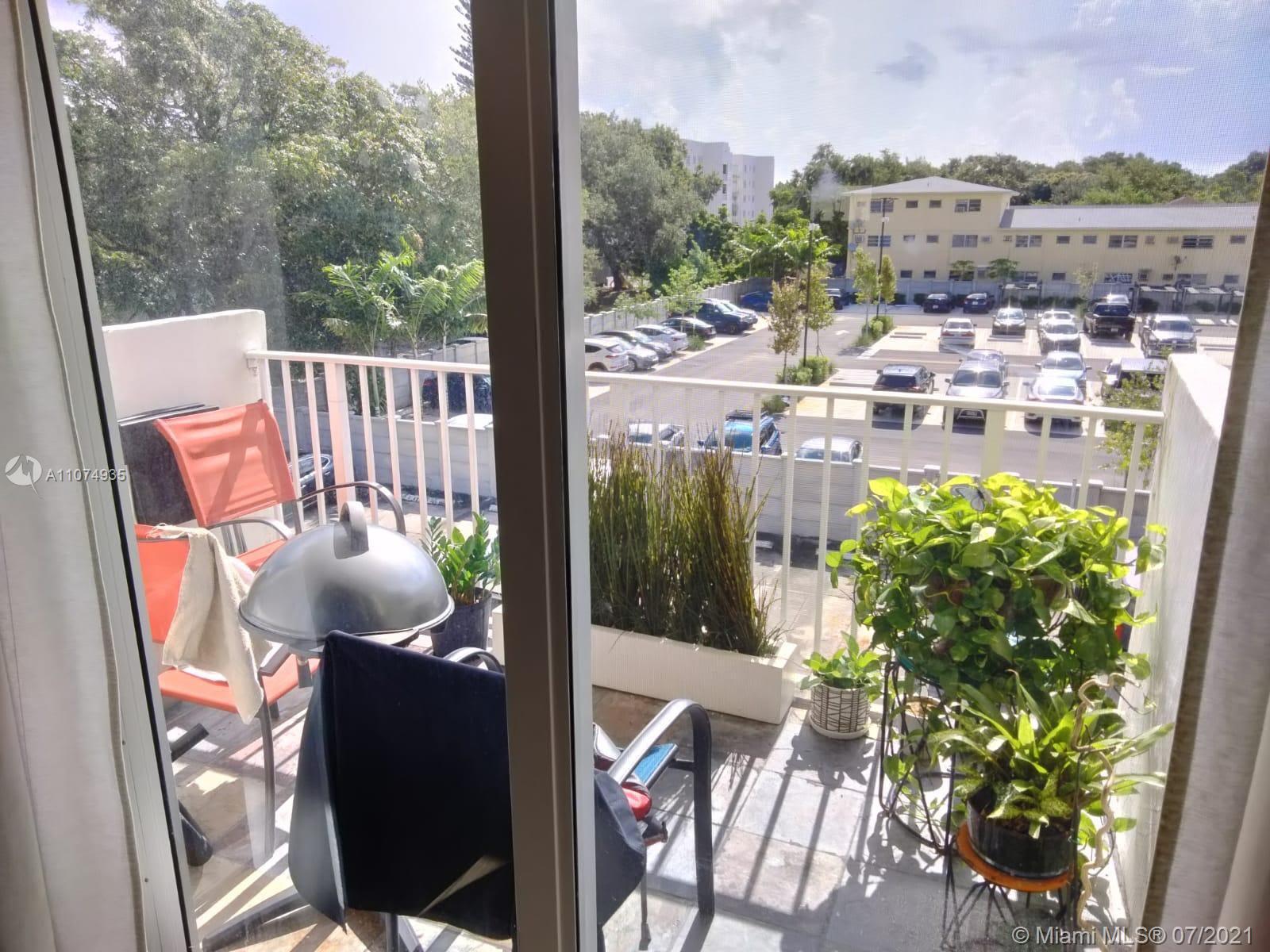 665 Northeast 83rd Terrace, Unit 314 Miami, FL 33138 - Photo 5 of 10 a view of a balcony with chair and wooden floor