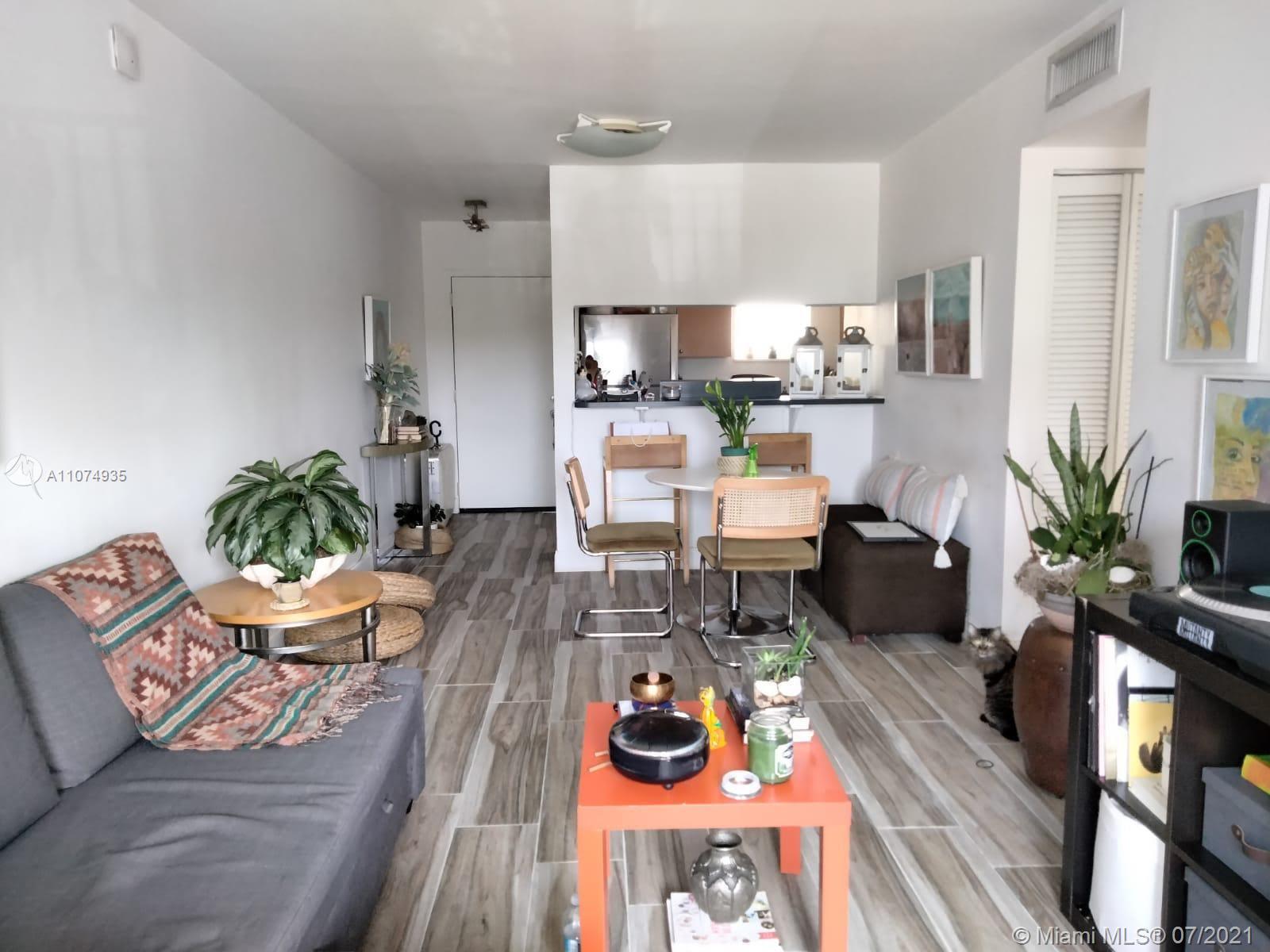 665 Northeast 83rd Terrace, Unit 314 Miami, FL 33138 - Photo 6 of 10 a living room with furniture and wooden floor