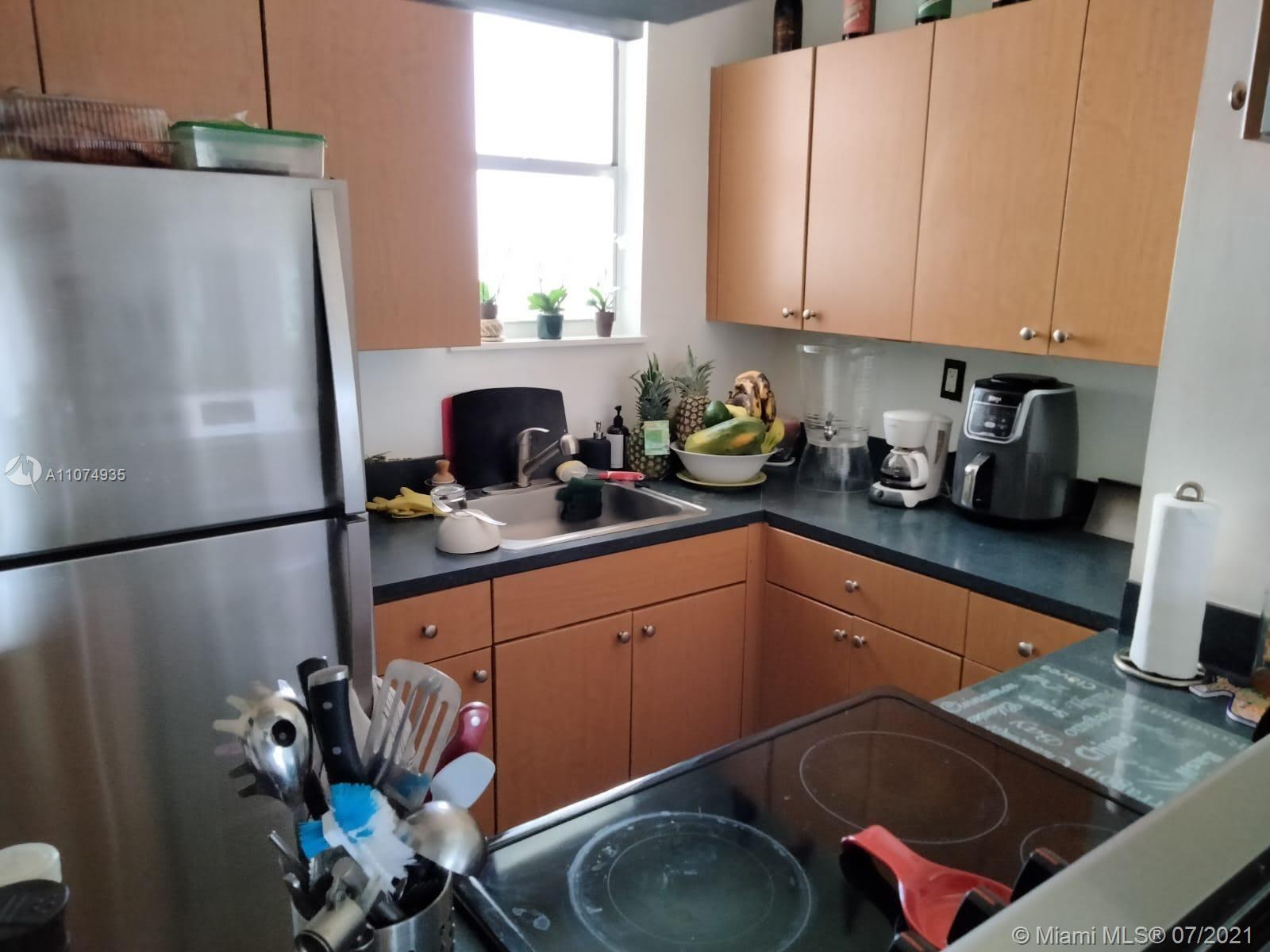 665 Northeast 83rd Terrace, Unit 314 Miami, FL 33138 - Photo 7 of 10 a kitchen with stainless steel appliances granite countertop a sink refrigerator and stove