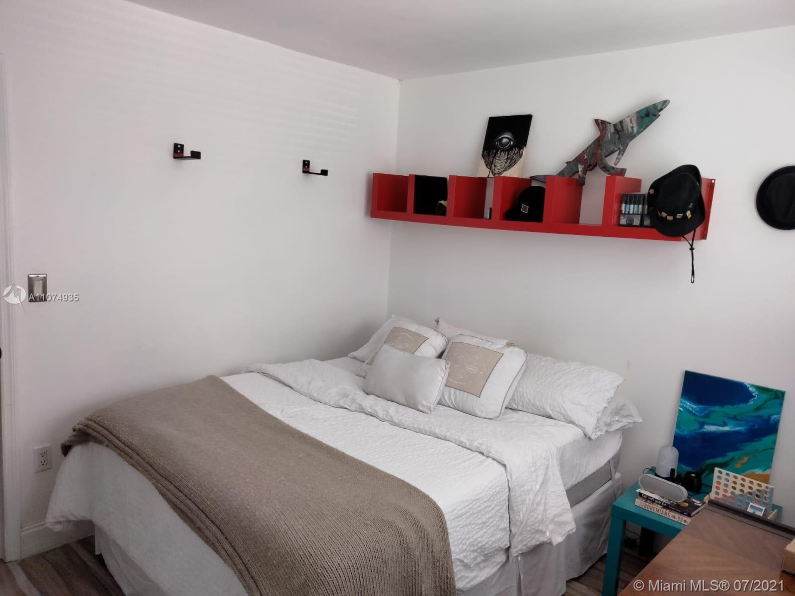 665 Northeast 83rd Terrace, Unit 314 Miami, FL 33138 - Photo 8 of 10 a bedroom with bed and cabinets