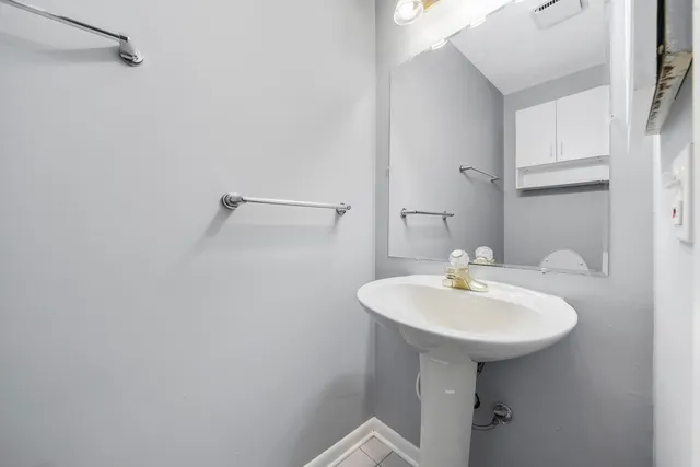 a bathroom with a sink a mirror and a toilet