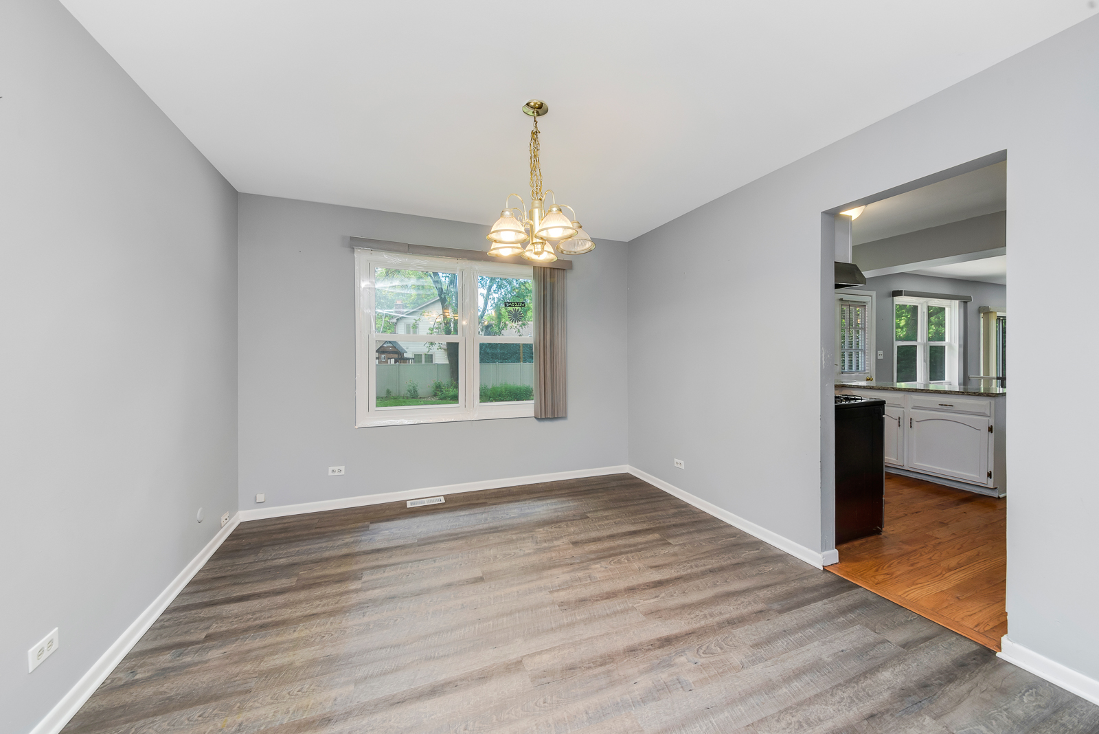 1441 Concord Drive Downers Grove, IL 60516 - Photo 6 of 16 wooden floor in an empty room with a window