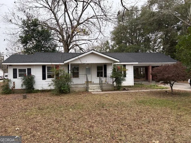 a front view of a house with a garden
