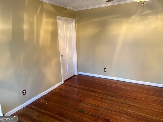 a view of room with wooden floor