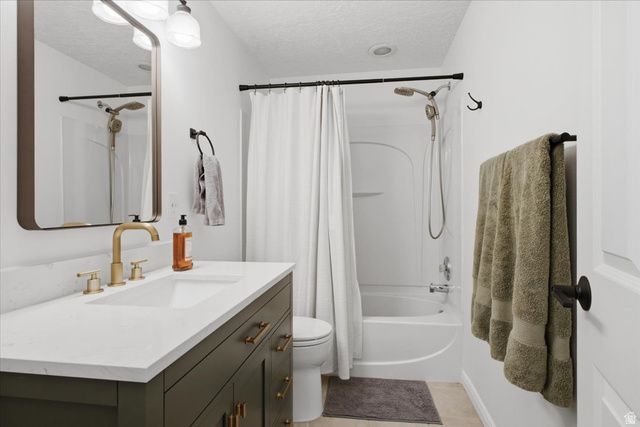 12151 Andrew View Circle Draper, UT 84020 - Photo 22 of 31 Bathroom vanity with a white countertop and gold-toned fixtures
