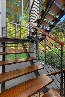 a bedroom with a bed and a lamp on dresser