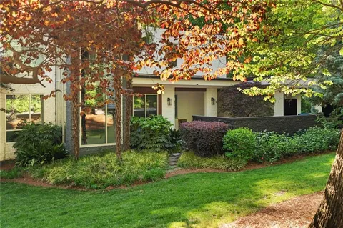 a front view of house with a garden