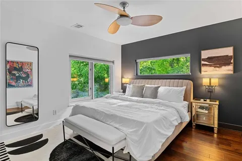 a living room with furniture kitchen view and a wooden floor