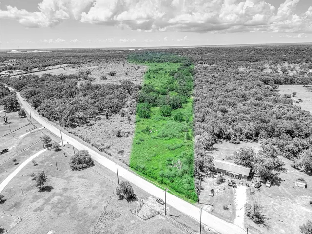 a view of a dry yard with wooden fence