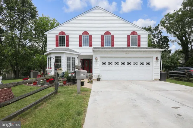 a view of house with yard and green space