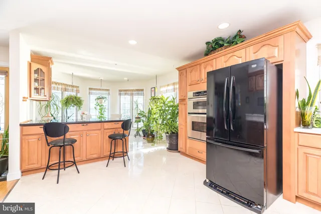 a kitchen with stainless steel appliances granite countertop a sink a stove cabinets and a window