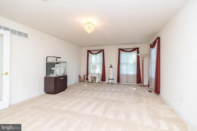 a view of a kitchen with a white cabinet door and a refrigerator