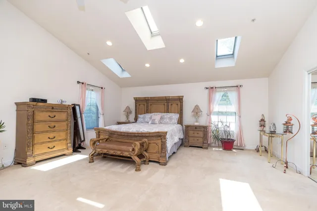 a bathroom with a granite countertop sink and mirror bathtub