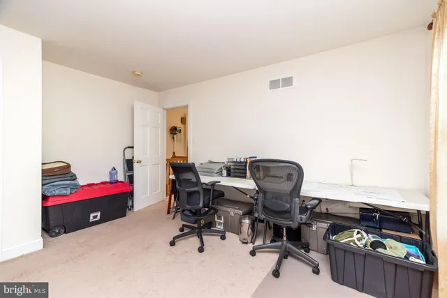 a kitchen with kitchen island granite countertop wooden cabinets and white appliances