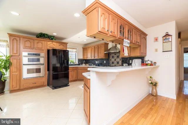 a kitchen with a refrigerator and a dining table