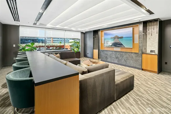 a living room with couches and a coffee table with kitchen view