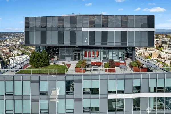 a view of a roof deck with couches and potted plants