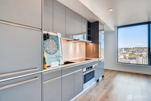 a view of kitchen with stainless steel appliances granite countertop a stove and a window
