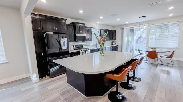 a view of kitchen with furniture and wooden floor
