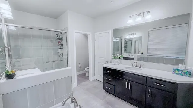 a bathroom with a tub sink and mirror