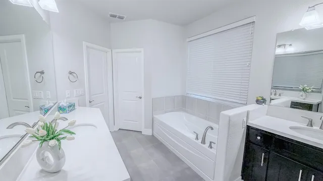 a white toilet sitting next to a white cabinet